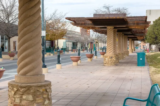 Covered walkway in Las Cruces, New Mexico, with planters. Trust our SEO Company for effective search engine optimization.