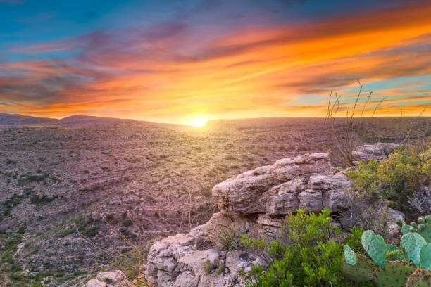 Sunset over desert terrain in Carlsbad, New Mexico. Let our Web Development Company build your online presence.