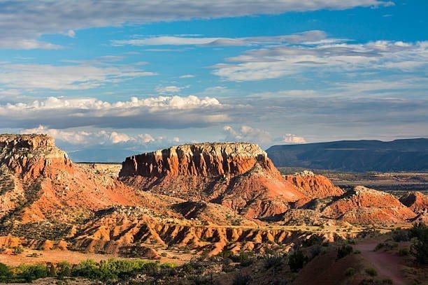 Red rock formations in Los Lunas, New Mexico, with clouds. A Web Design Company can turn your website into a masterpiece.