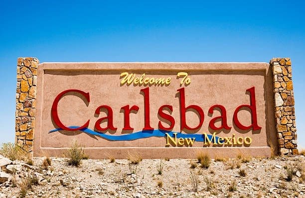Welcome sign in Carlsbad, New Mexico, with decorative pillars. Partner with an our SEO Company to grow your business online.