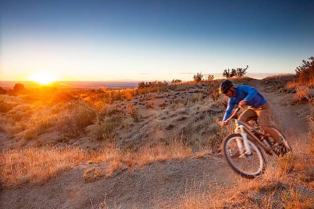 Mountain biker on desert trail near North Valley, New Mexico. Let our Web Development Company build your business website.
