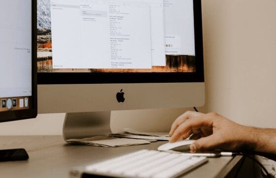 large mac desktop computer with code on screen