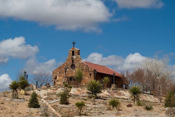 Stone church in Española, New Mexico, under a bright sky. Our Web Development Company builds beautiful, functional websites.