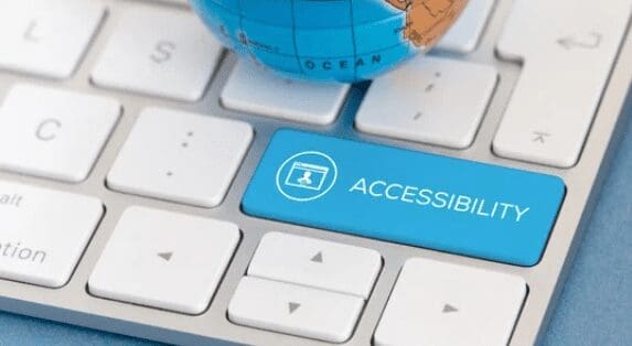 white keyboard with shift key turned blue with the word "accessibility"