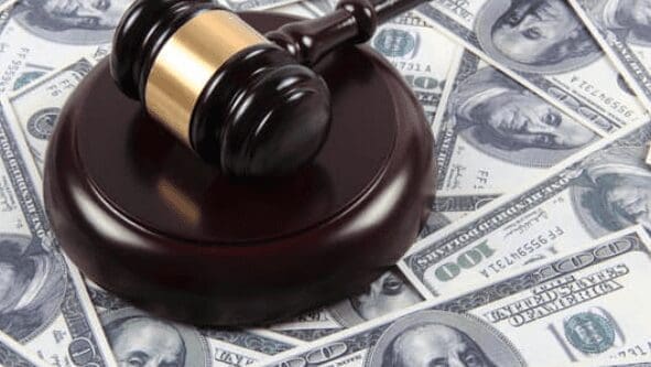 a judges gavel on a pile of united states currency