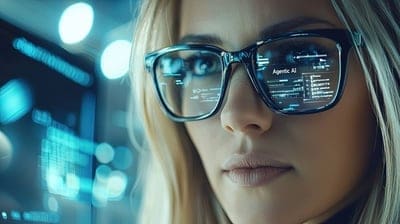Beyond the AI Hype: 10 Technologies Actually Delivering ROI in 2025 1 Woman with glasses, with agentic AI written in the reflection.